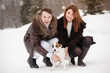 Happy couple and their dog Jack Russell Terrier at the winter park