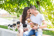 Young couple in love,siting and enjoy in park with his dogs