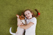 Curly little girl embracing puppy jack russell.