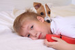 Young Boy Hugging His Dog in Bed